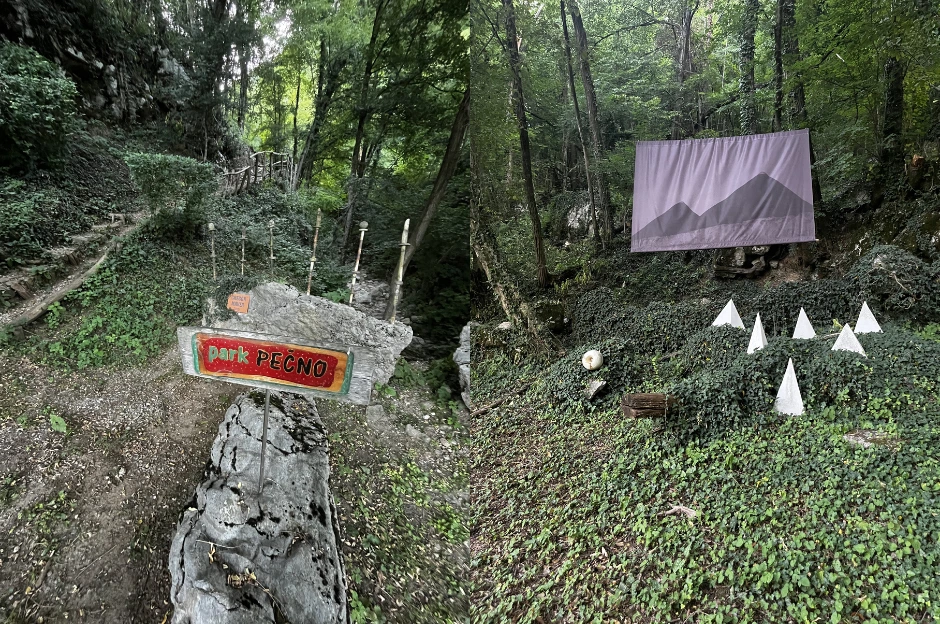 Sign of Pečno Park surrounded by nature and a walking path and art instalation between trees